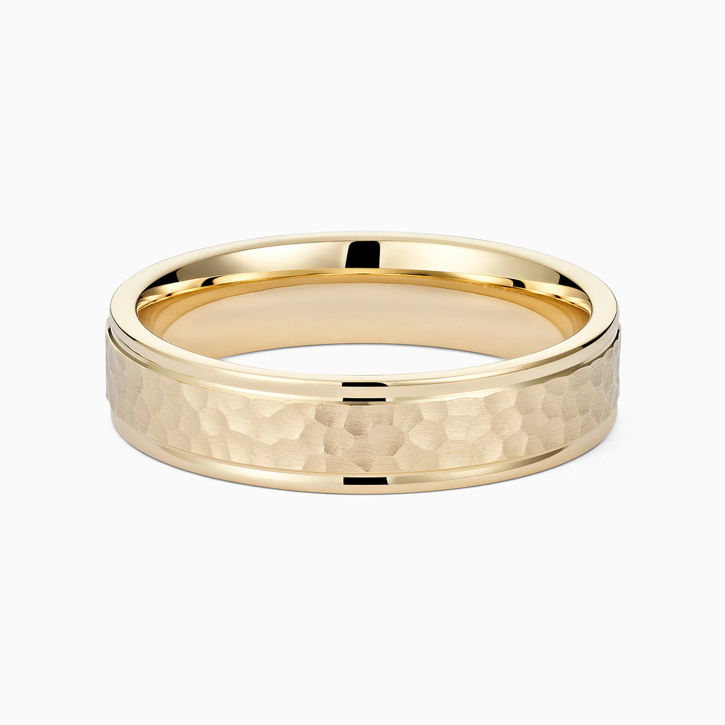 Angled view of Ecksand's Brushed Hammered Wedding Ring in 18k Yellow Gold, Band: 5mm