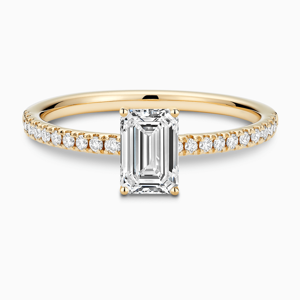 The Ecksand Basket-Setting Diamond Engagement Ring with Diamond Bridge shown with Emerald in 18k Yellow Gold