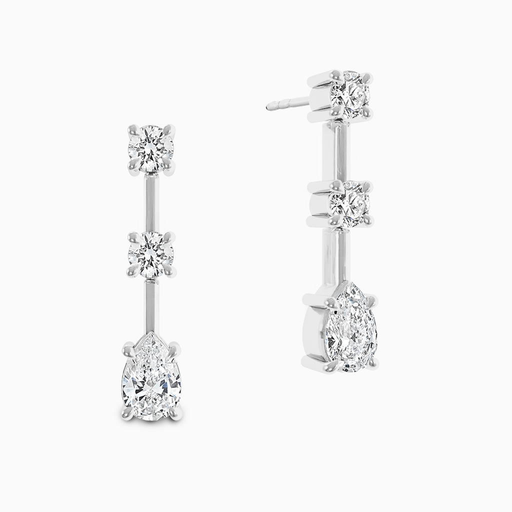 Canadian-made three-stone diamond dangle earrings with a pear-shaped drop in 18K white gold.