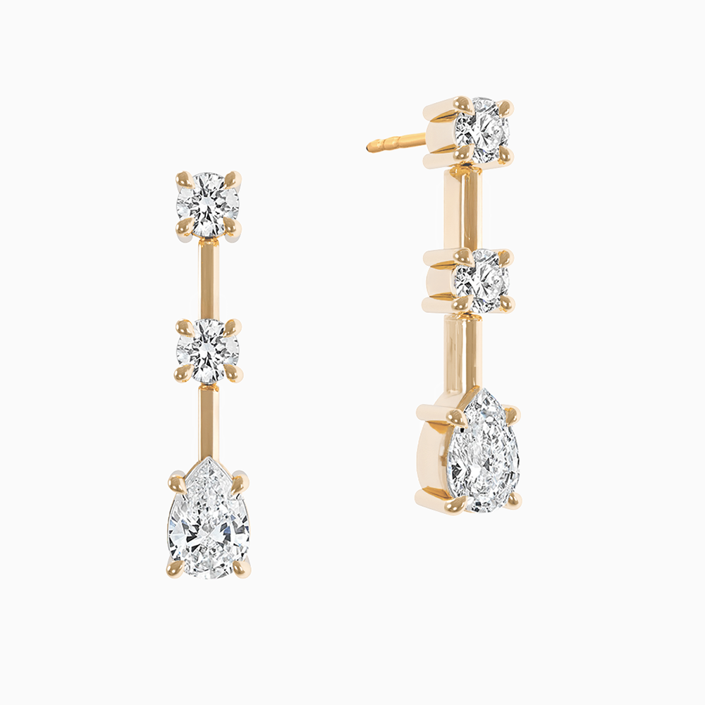 Canadian-made dangle earrings with pear and round cut diamonds set in 18K yellow gold.