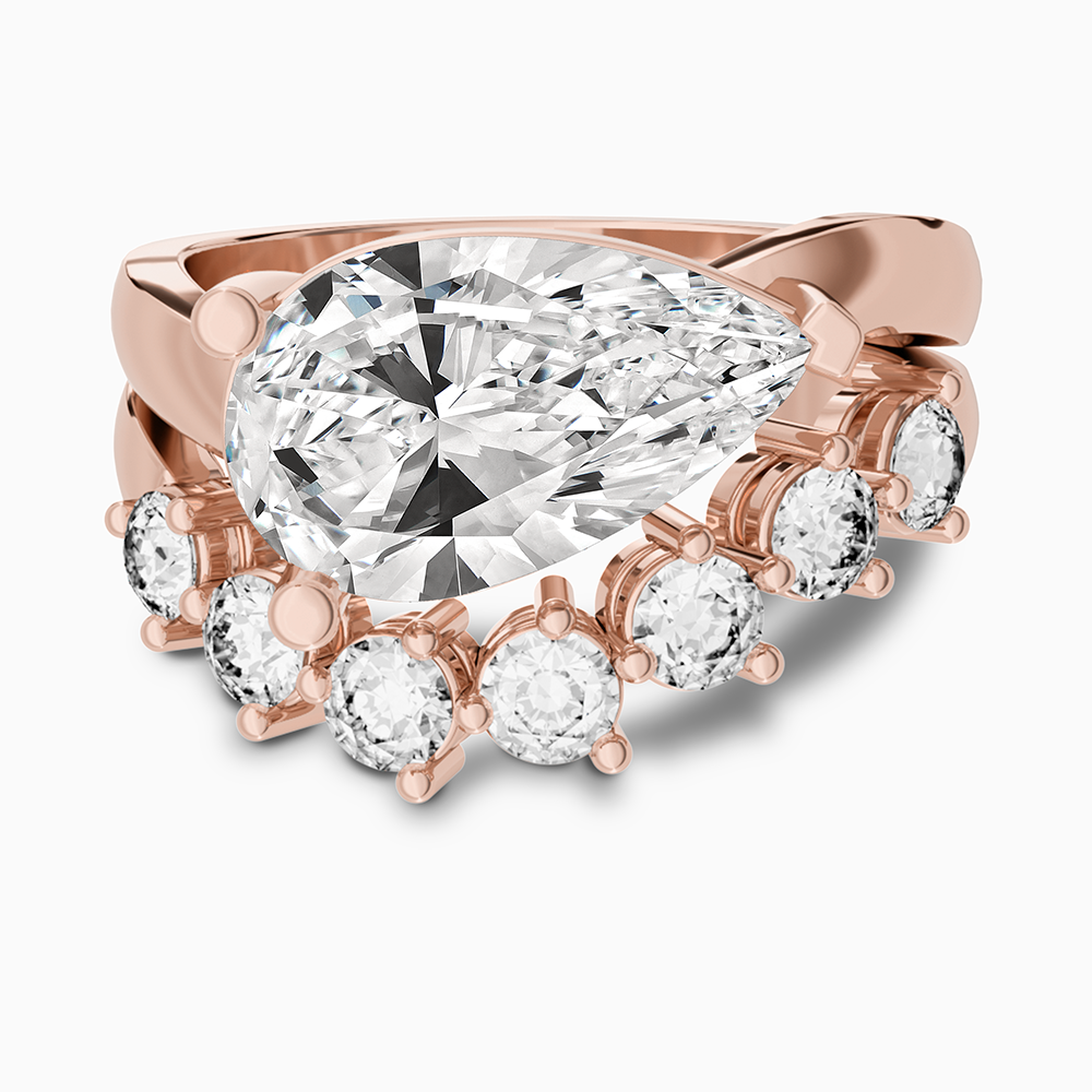 Canadian-made pear-cut diamond engagement ring with a curved diamond wedding ring in 14K rose gold.