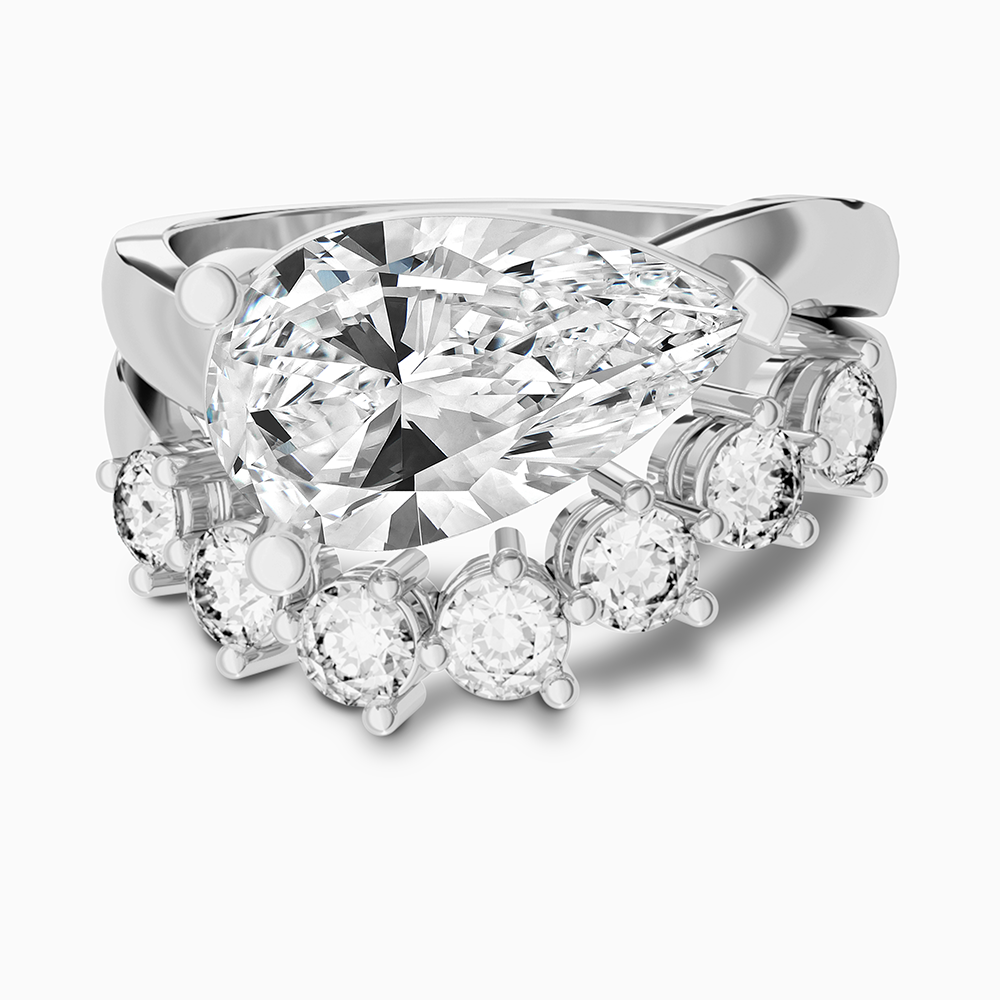 Canadian-made pear diamond engagement ring with a curved diamond wedding band. Bridal set in 18K white gold.