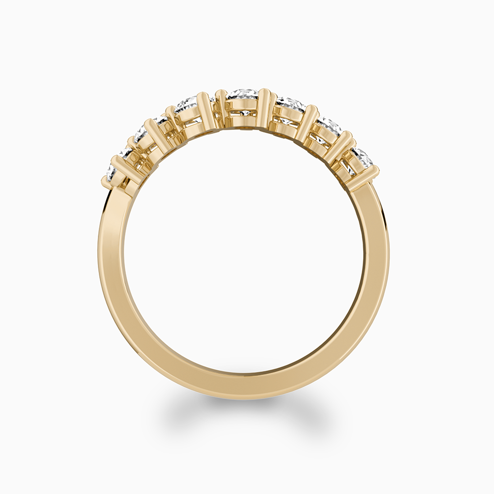 Side view of a Canadian-made seven-stone diamond wedding ring in 18K yellow gold.