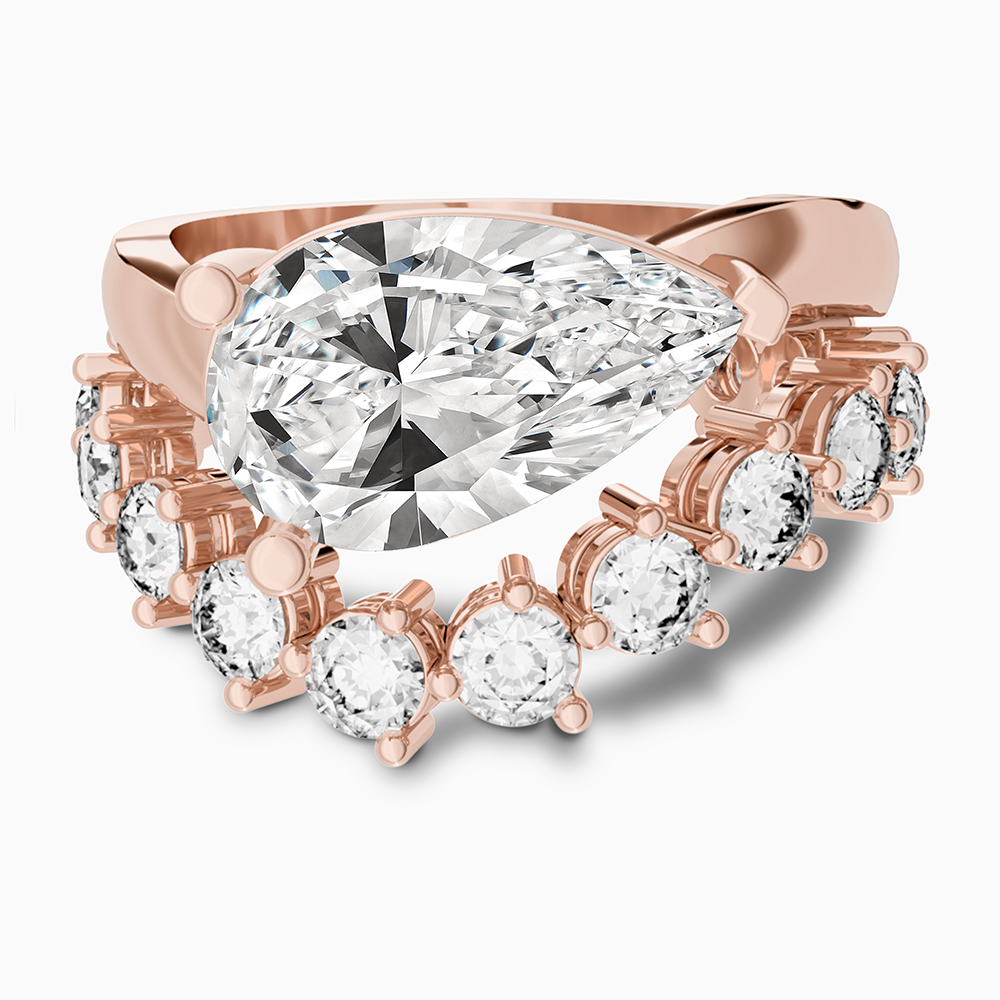 Canadian-made pear diamond engagement ring bridal set with a contoured wedding band in 14K rose gold.