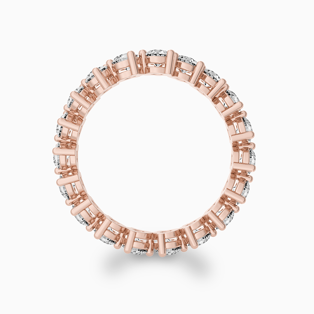 Canadian-made diamond eternity wedding ring in 14K rose gold. Shared-prong setting by Ecksand.