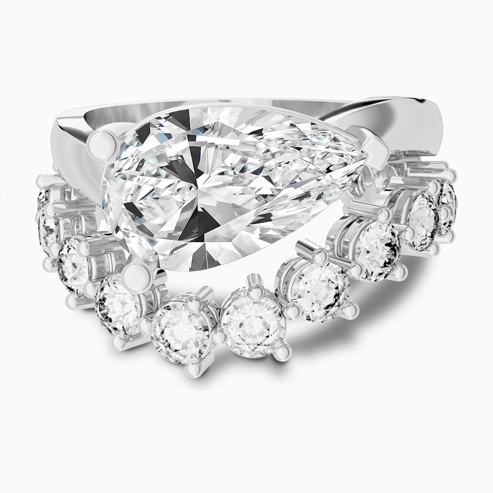 Canadian-made Ecksand ring stack with a pear diamond engagement ring & wedding band in 18K white gold.