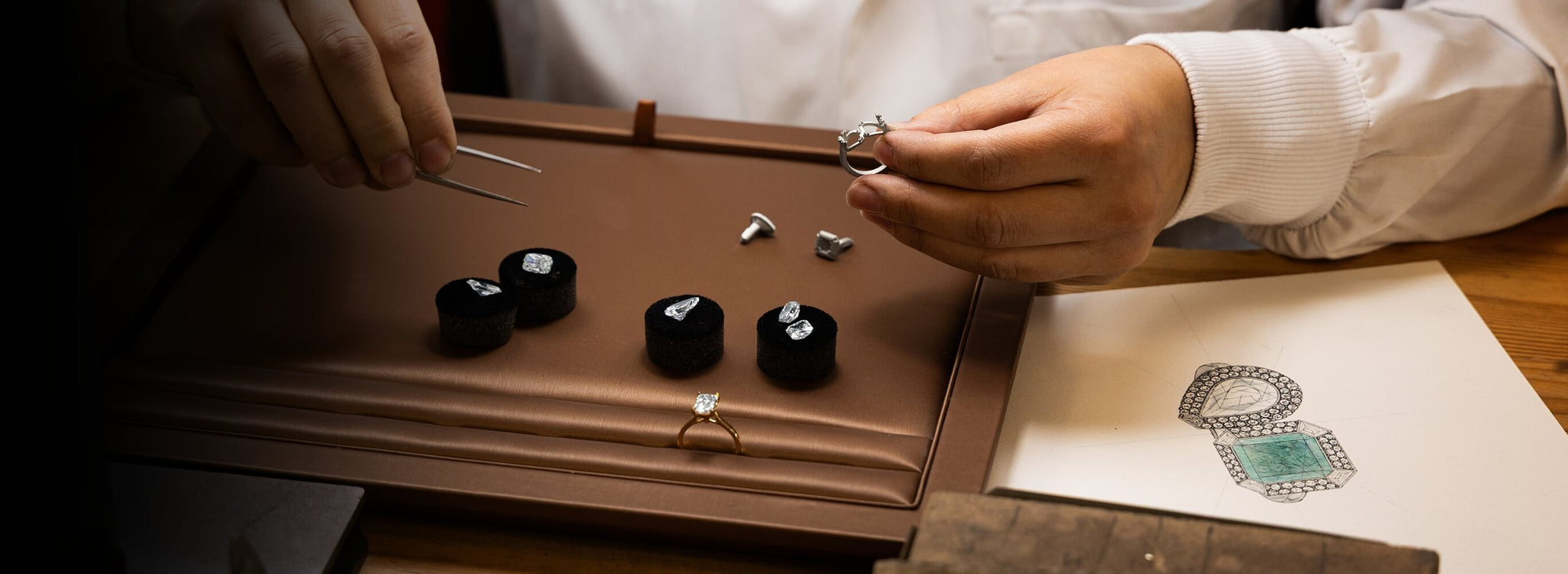 a jeweller picking diamonds for a two stone diamond engagement ring