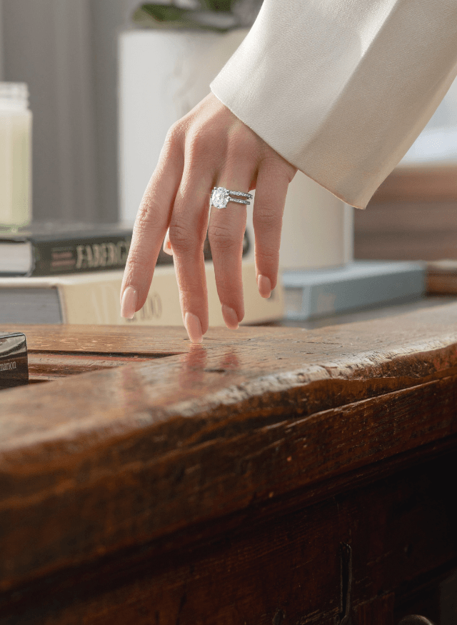 model wearing canadian-made ecksand 18k white gold oval solitaire diamond engagement ring with pavé band and diamond pavé wedding ring
