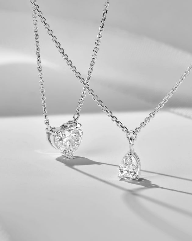 white gold ecksand diamond necklaces on white background