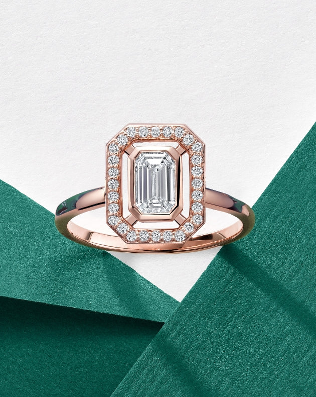 ecksand rose gold cardinal engagement ring on green and white backdrop