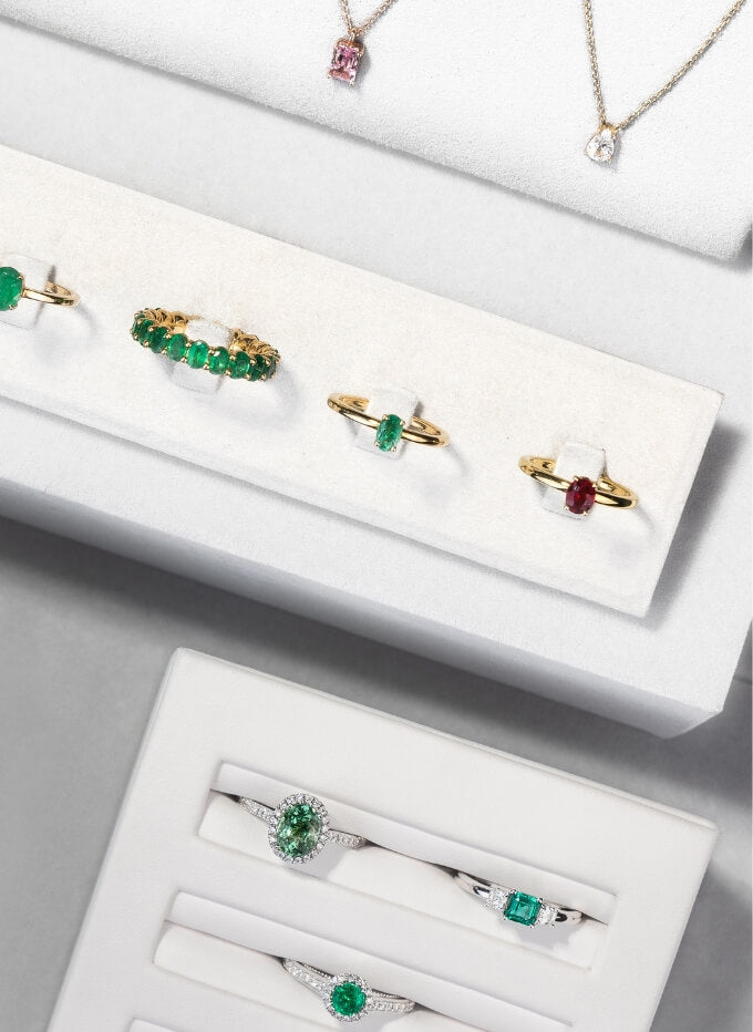 ecksand yellow and white gold emerald and ruby rings in white displays