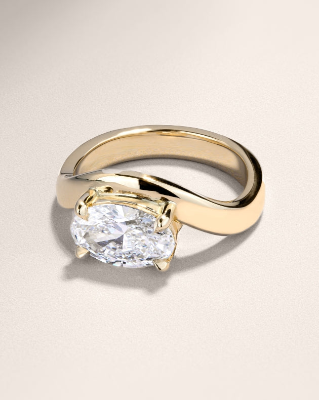 Canadian-made custom oval diamond engagement ring with gold band in 18K yellow gold.