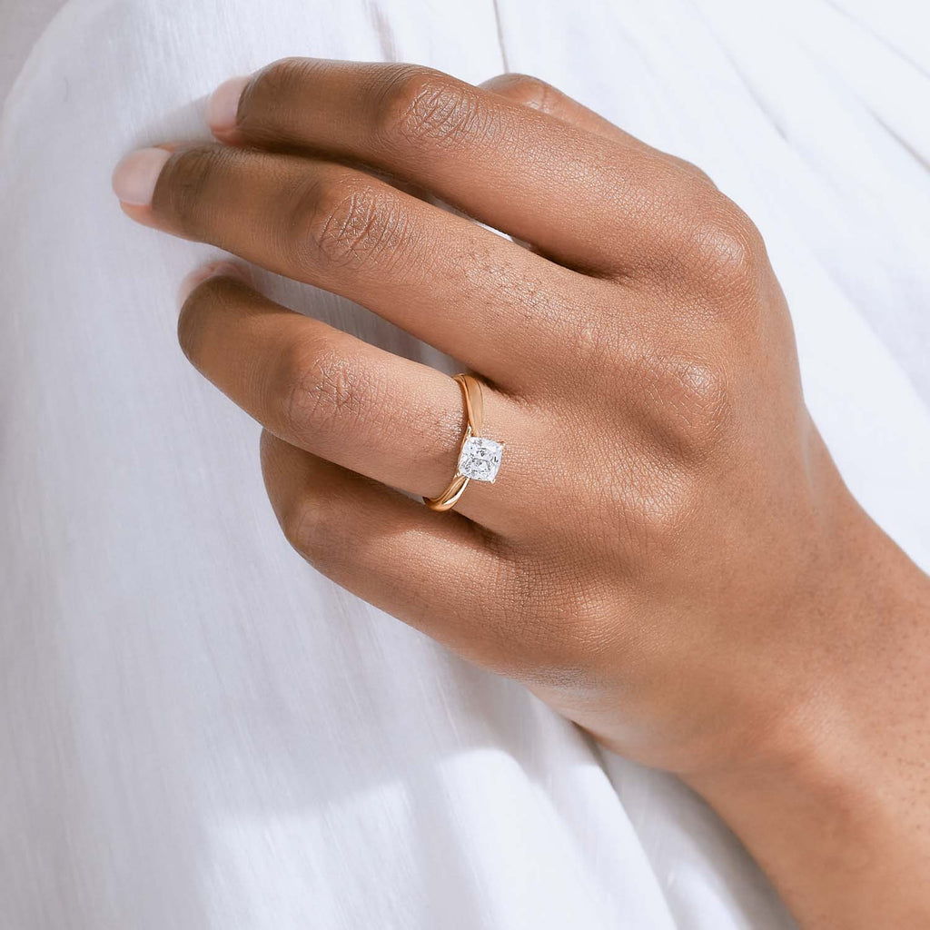 The Ecksand Iconic Tapered Band Solitaire Diamond Engagement Ring with Secret Heart shown with  in 