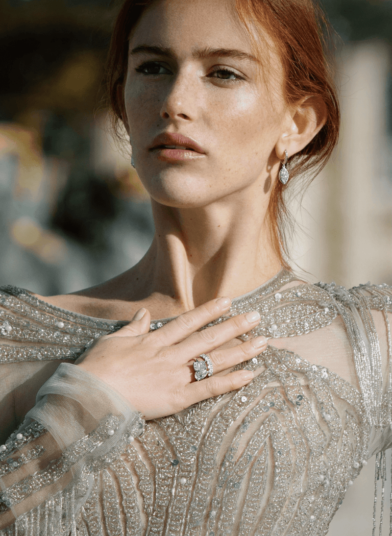model wearing a canadian-made 18k white gold two stone diamond engagement ring with an oval diamond eternity ring