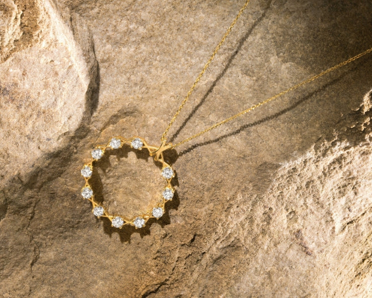 Canadian-made 18k yellow gold diamond necklace on a rock background by Ecksand