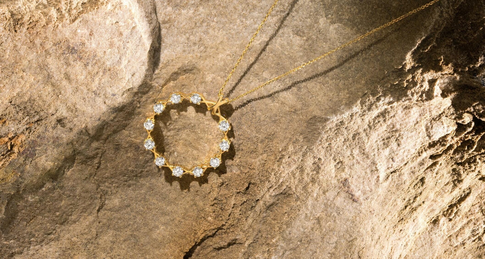 Canadian-made 18k yellow gold diamond necklace on a rock background by Ecksand