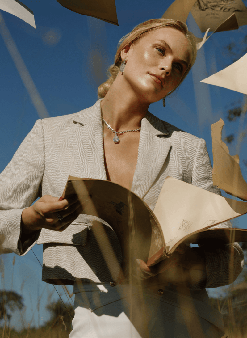 model wearing a canadian-made 18k yellow gold reversible diamond necklace with 18k white gold dangle earrings from ecksand's aura collection