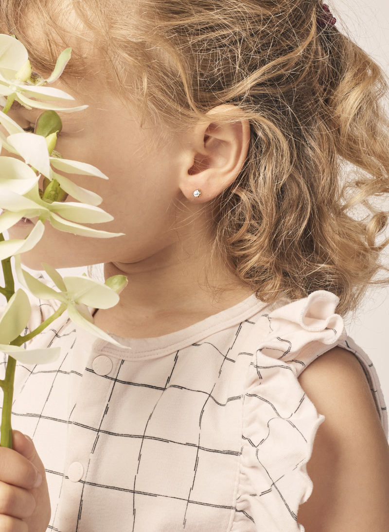 a girl wearing canadian-made 14k rose gold pearl earrings from ecksand's little seasons collections for moms and kids