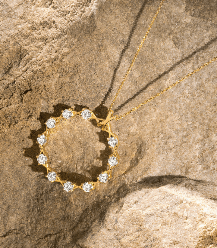 Canadian-made 18k yellow gold diamond circle necklace on a rock background from Ecksand's XO Collection