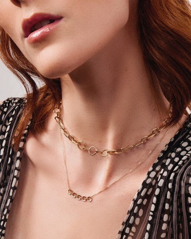 Model wearing Ecksand’s gold duel necklaces