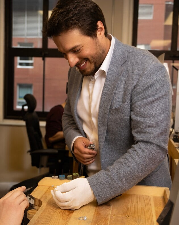 co-founder of ecksand yoan gehant-vidoni quality checking an ecksand diamond engagement ring in the montreal atelier