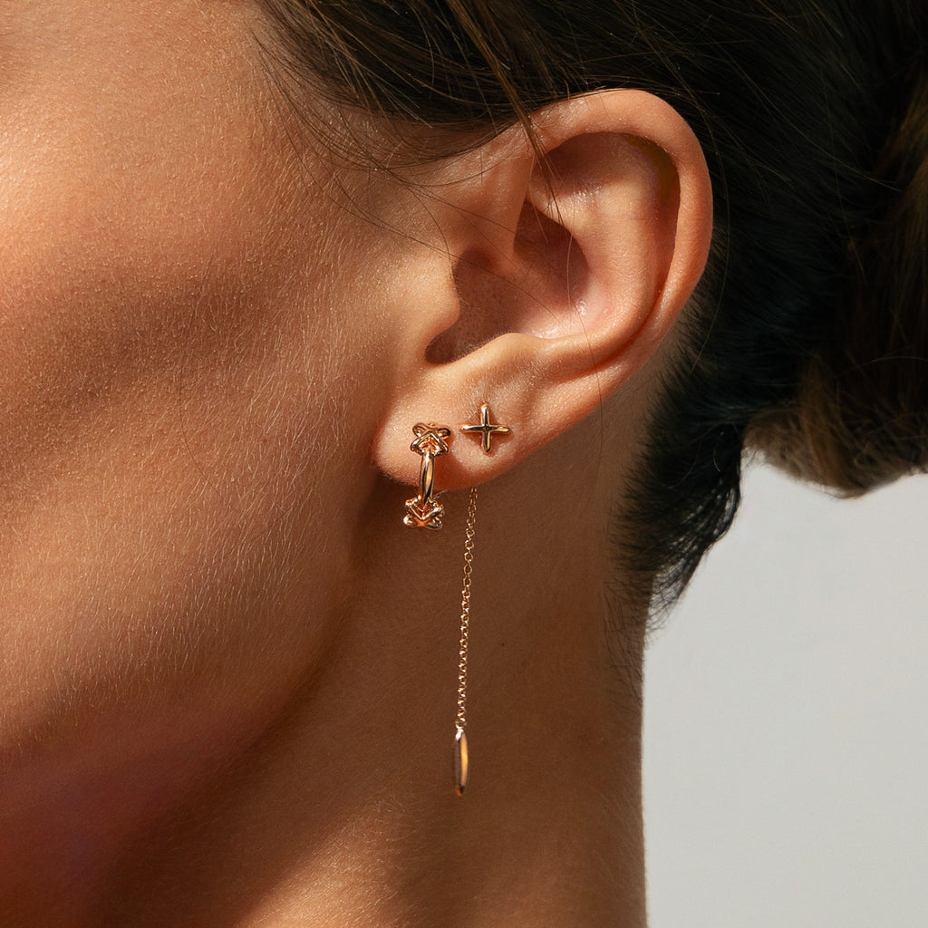 The Ecksand Three X's Hoop Studs shown with  in 