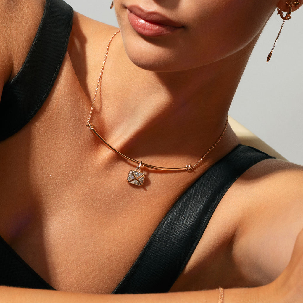 The Ecksand X Marks the Spot Necklace shown with  in 