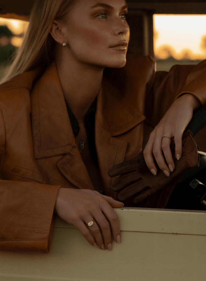model wearing canadian-made 18k yellow gold east west old mine diamond engagement ring and curved textured wedding ring from ecksand's dynasty collection