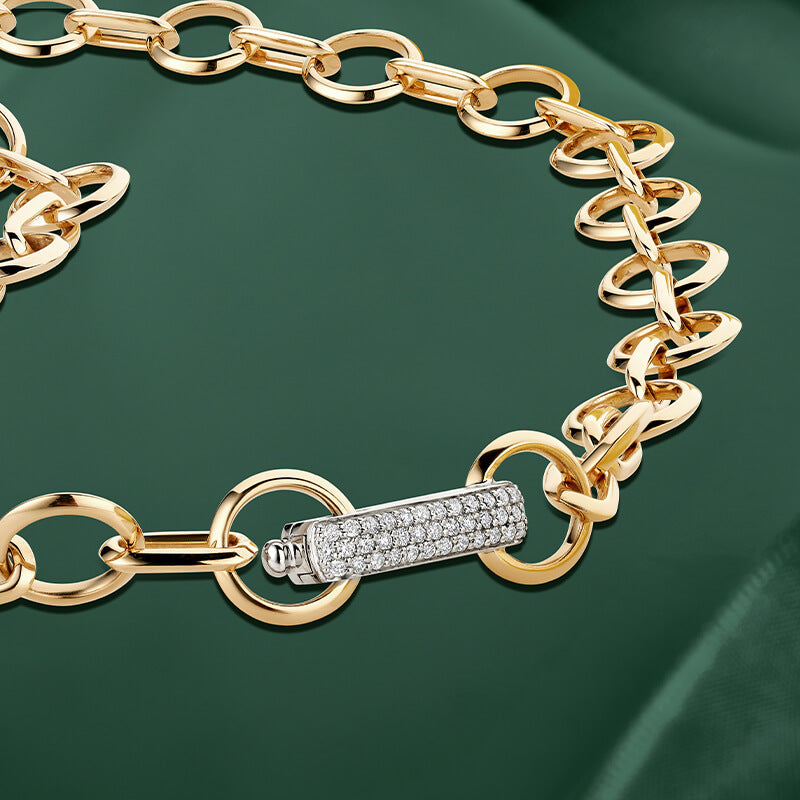 ecksand yellow and white gold oversized chain necklace with diamond pave accents on green background