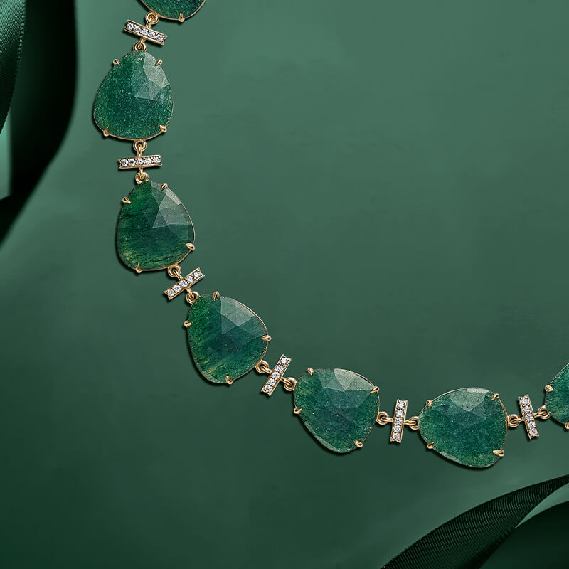 ecksand yellow gold chain necklace with green aventurine gemstones and diamond accents on green background