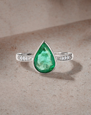 The Ecksand Pear Emerald Engagement Ring With Tapered Diamond Band