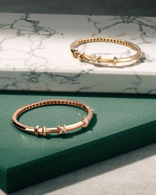 Two Canadian-made diamond bangles in 14K rose gold and 18K yellow gold.