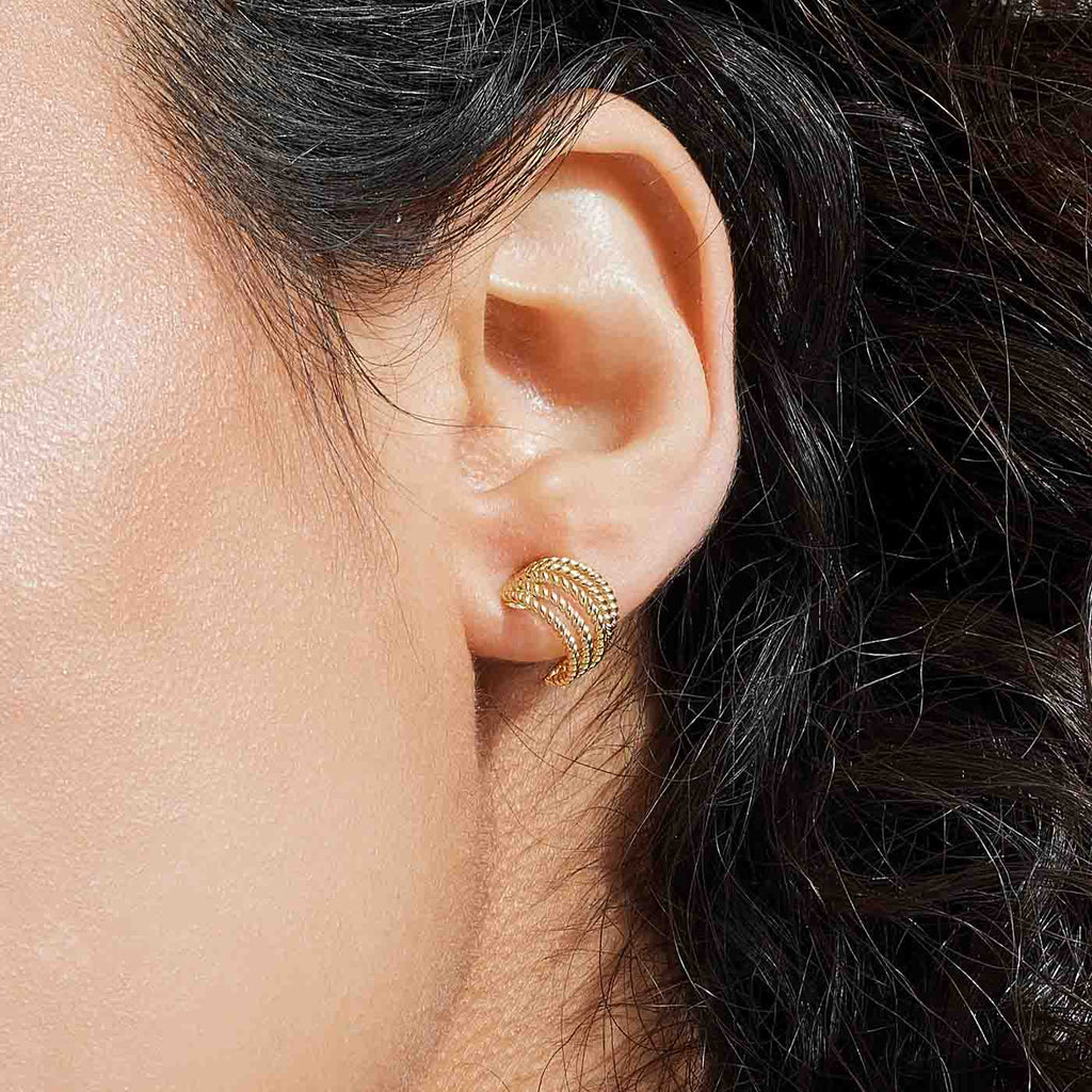 The Ecksand Twisted Gold Cuff Hoop Earrings shown with  in 