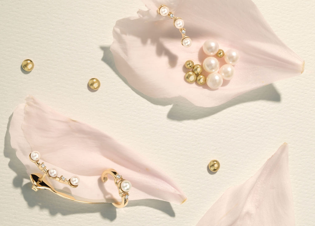 yellow gold diamond and akoya pearl earrings on flower petals with gold nuggets and pearls on a white background from ecksand's wonder collection