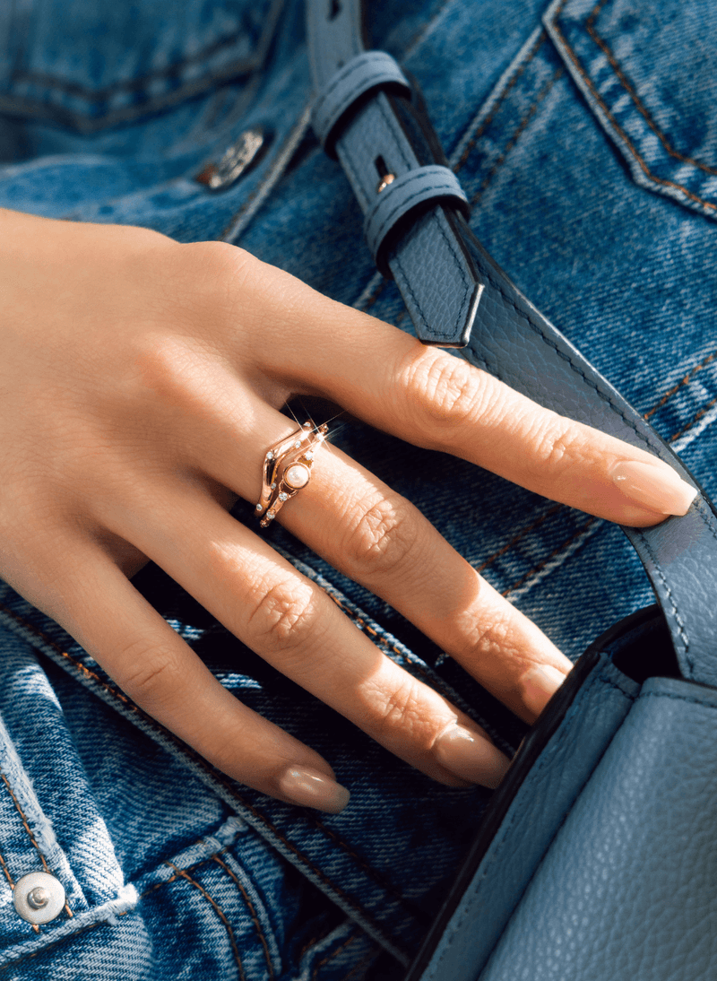 a model wearing canadian made 18k yellow gold diamond and akoya pearl rings from ecksand's wonder collection
