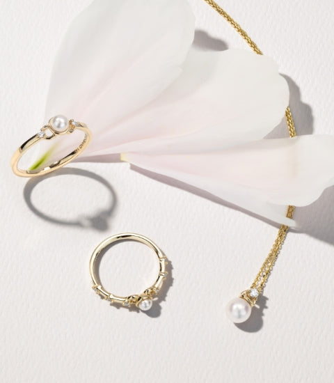 18k yellow gold natural diamond and akoya pearl rings with an 18k yellow gold natural diamond and akoya pearl pendant necklace