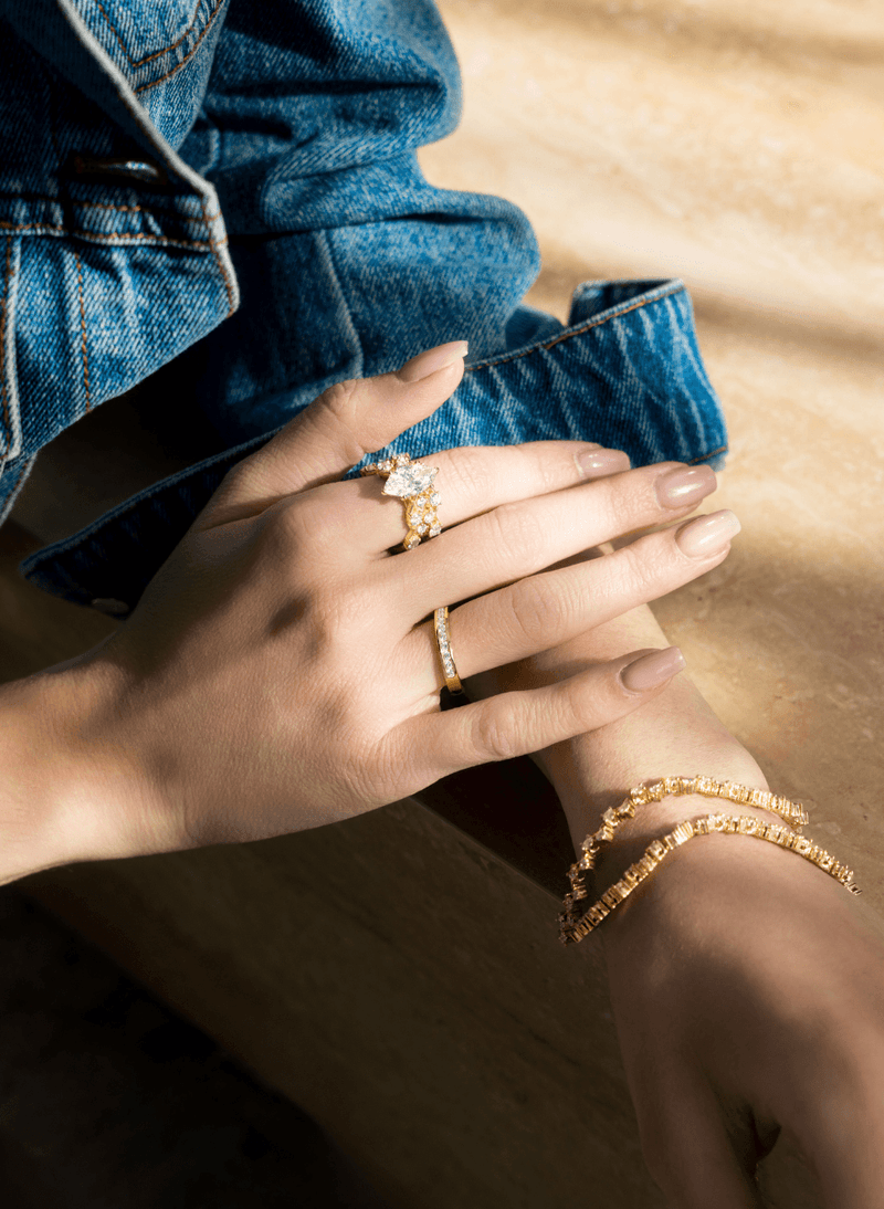 a model wearing canadian-made 18k yellow gold diamond jewelry from ecksand's xo collection.