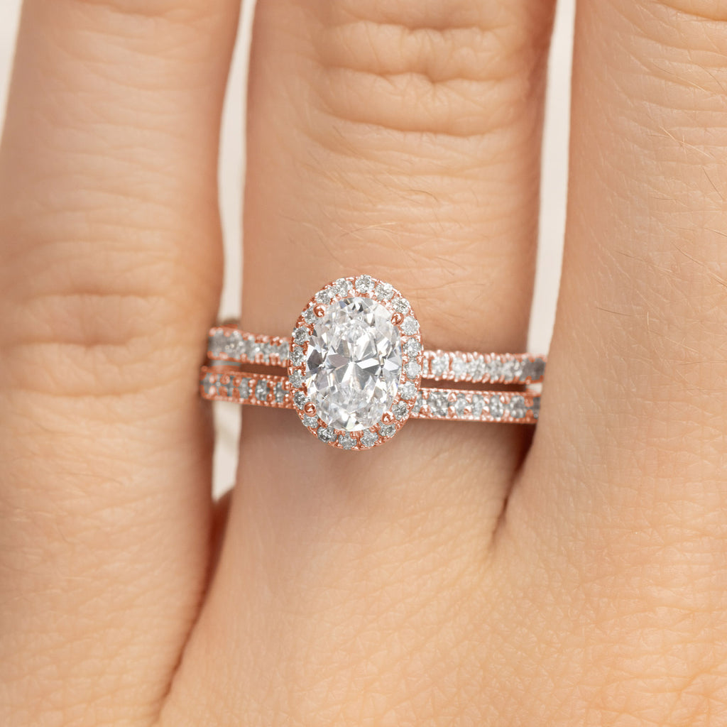 Canadian-made oval diamond halo engagement ring and wedding band set in 14K rose gold.