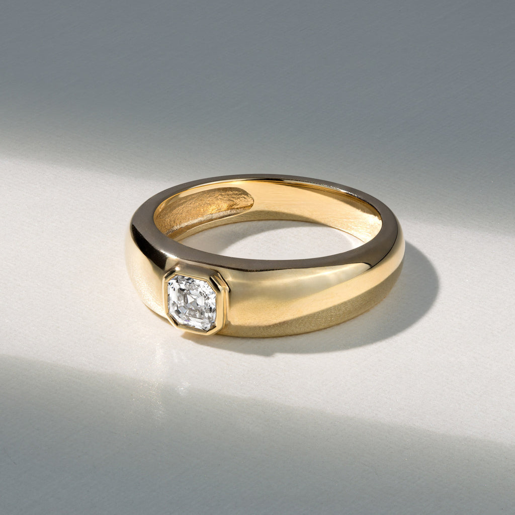 Canadian-made ring with an Asscher-cut diamond in a modern 18K yellow gold bezel setting.