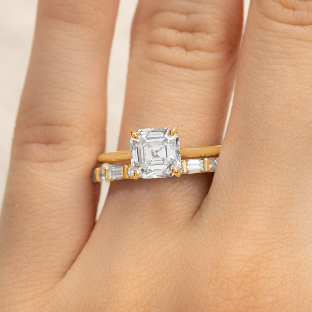 Ecksand Asscher cut diamond engagement ring with a baguette diamond wedding ring. Canadian-made in 18K yellow gold.