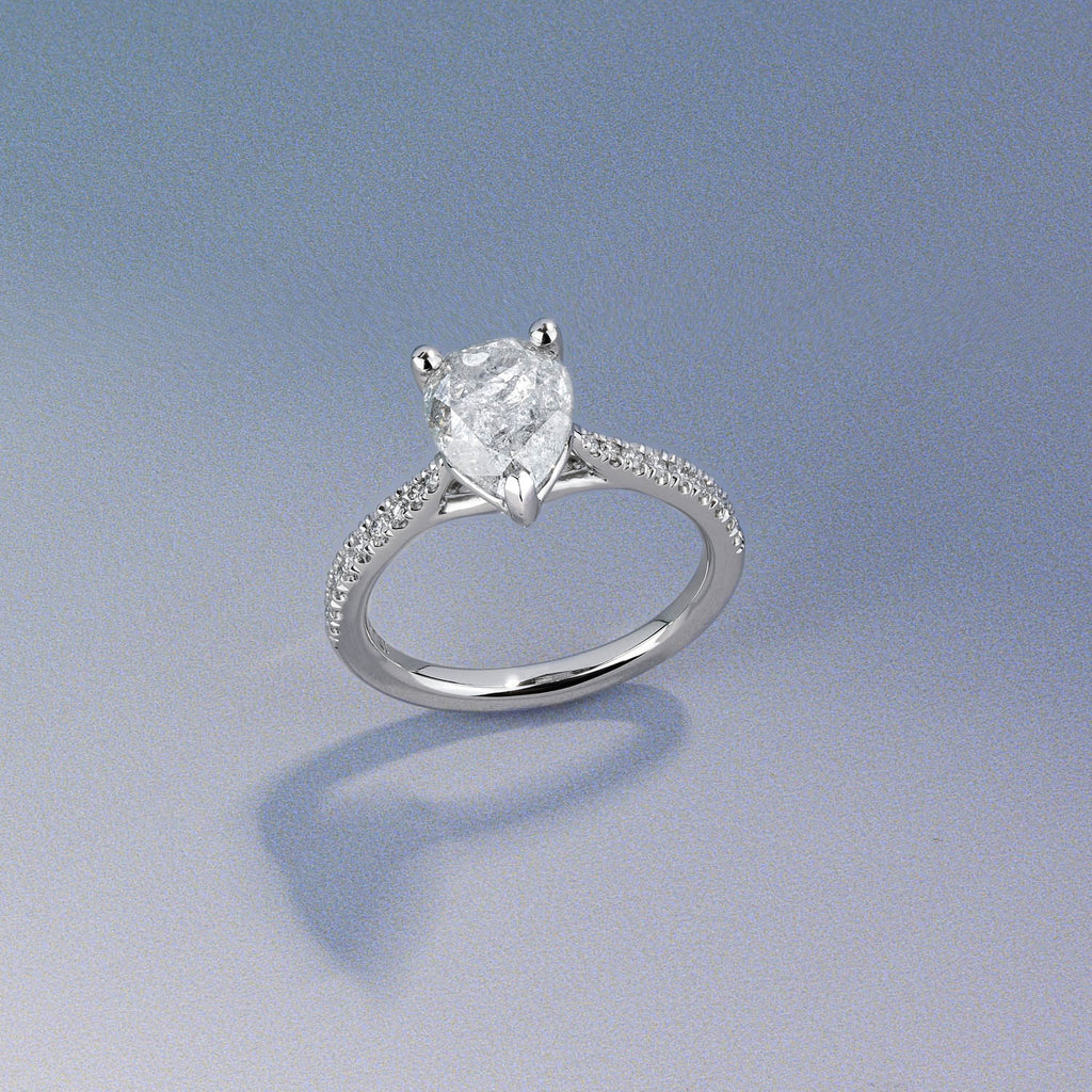 Canadian-made heart-shaped diamond engagement ring with a pavé diamond band in 18K white gold.