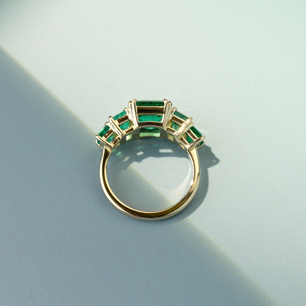 Canadian-made Ecksand five-stone emerald wedding ring in an 18K yellow gold setting.