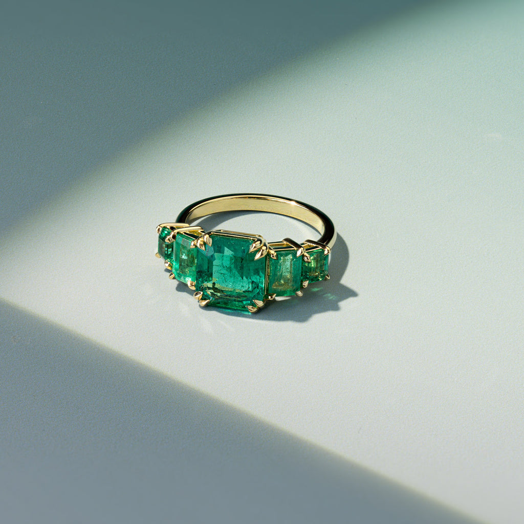 Ecksand five-stone ring with emerald-cut emeralds on a Canadian-made 18K yellow gold band.