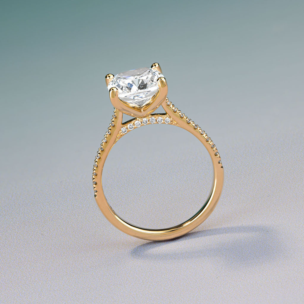 Ecksand Canadian-made cushion cut diamond engagement ring with a pavé band in 18K yellow gold.