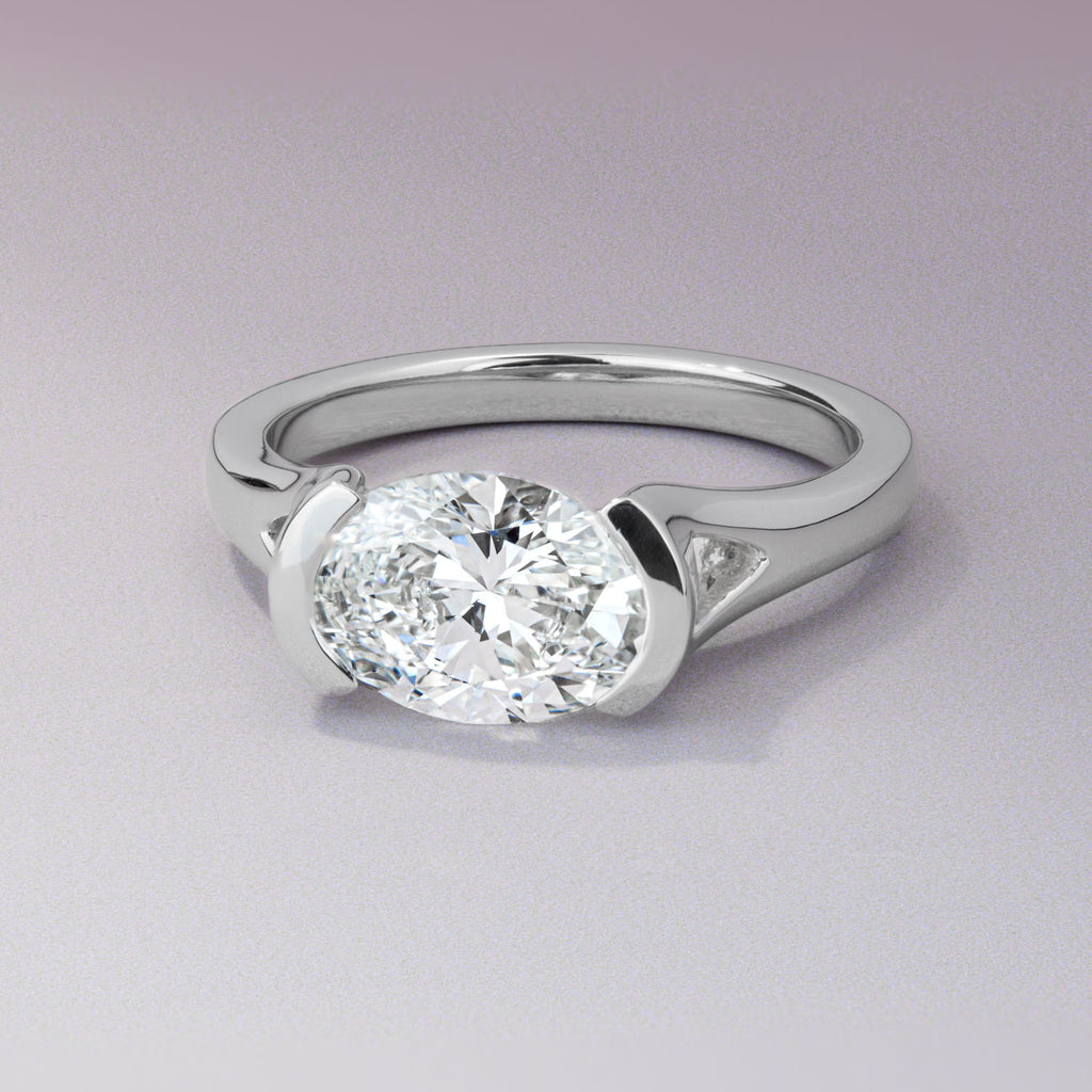 Canadian-made solitaire engagement ring with an east-west oval diamond set in 18K white gold.