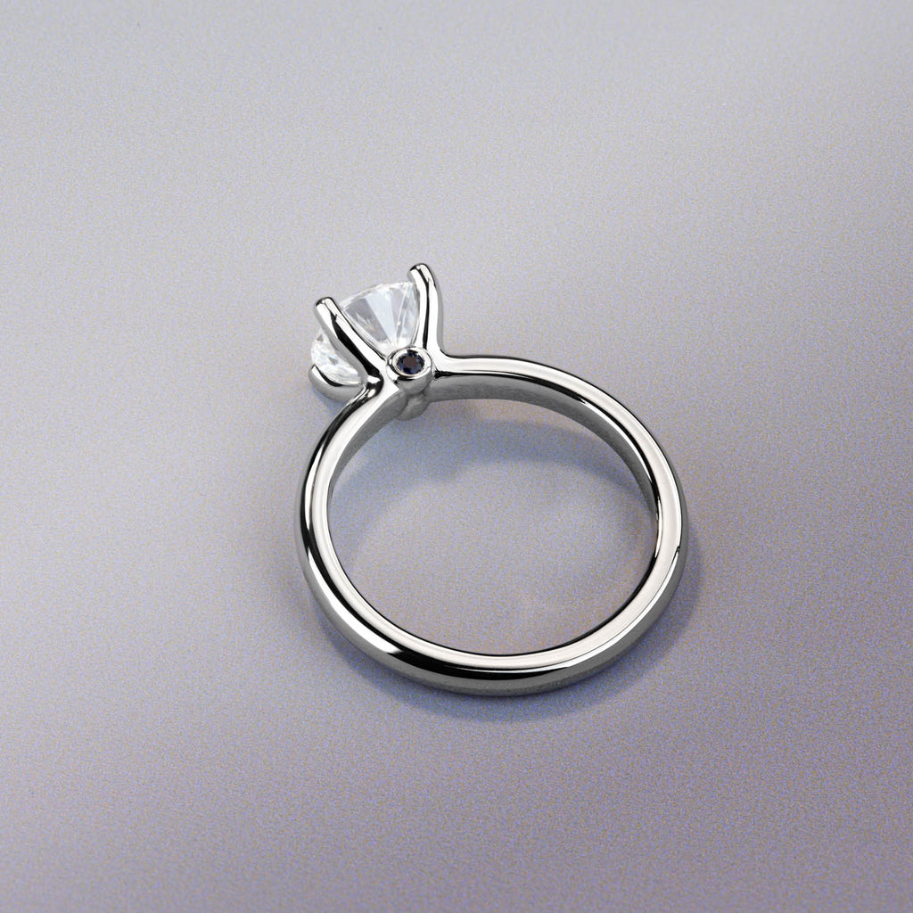 Ecksand Canadian-made solitaire diamond engagement ring in 18K white gold with a secret blue sapphire.