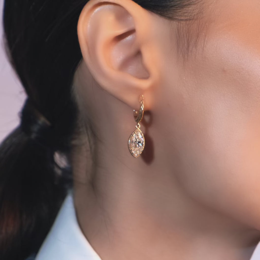 Model wearing Dragon Scale Gold Dangle Earrings with Marquise Diamonds in 18k yellow gold