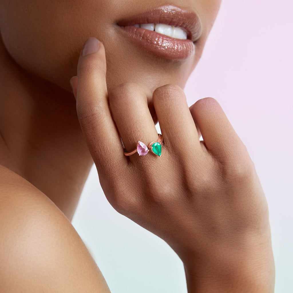 The Ecksand Two-Stone Pear-Cut Pink Sapphire and Emerald Ring shown with  in 