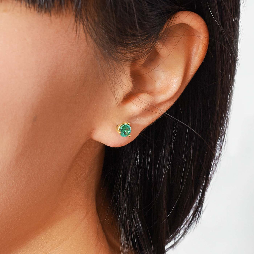 The Ecksand Round Emerald Stud Earrings shown with  in 