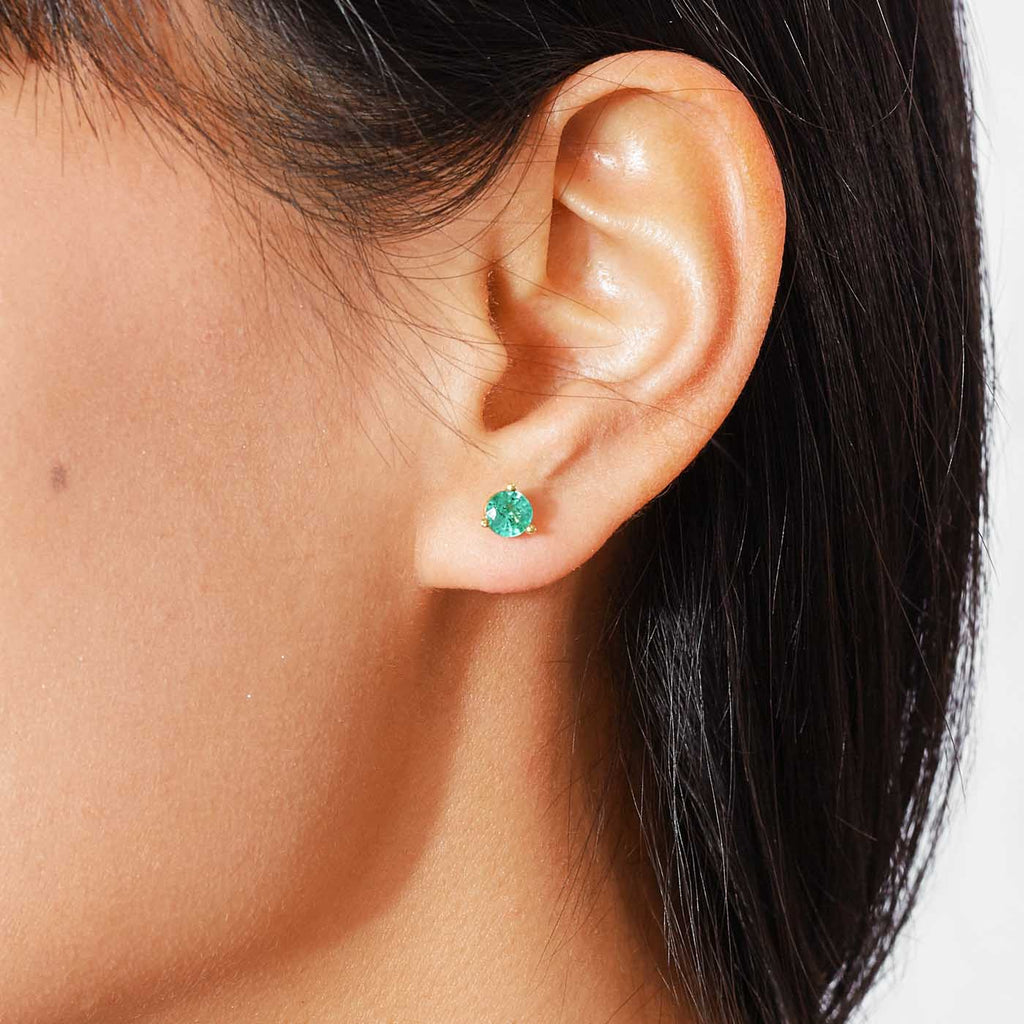 The Ecksand Round Emerald Stud Earrings shown with  in 